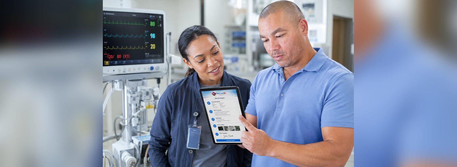 Digital service report and client signature | BiomedRx App Clinician signing a digital service report in the BiomedRx App beside a patient monitor